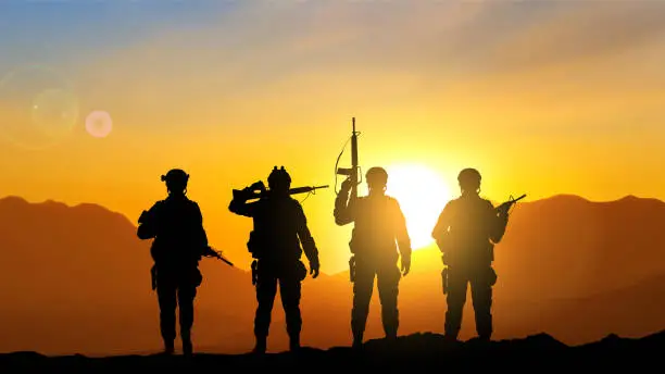 Vector illustration of Six military silhouettes on sunset sky background