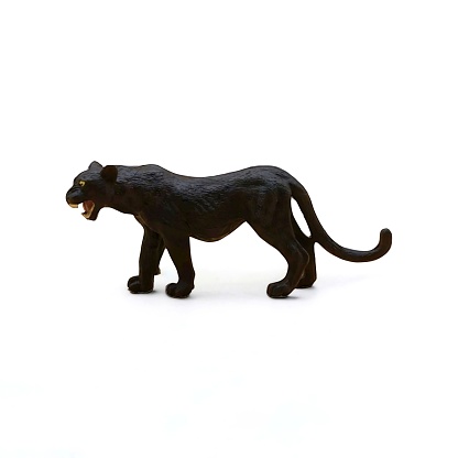 Close-up of a black tiger animal toy miniature side view on a white background