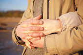 close up of man and woman hands crossing fingers. Hugging couple