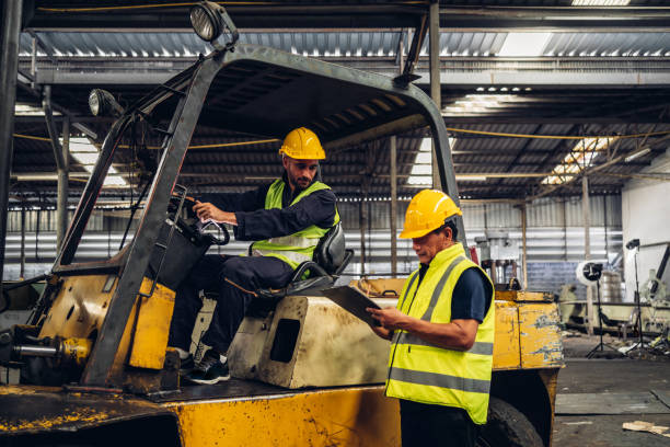 istock Workers Factory or Engineering work at factory site check up machine or products in site. Foreman or Technician checking Material or Machine on Plant. Heavy industry factory concept. 1496840942