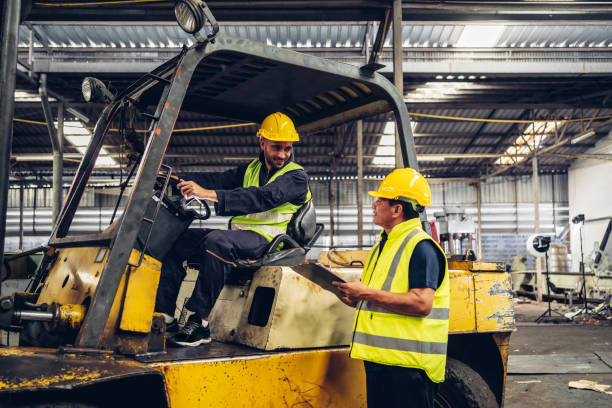 istock Workers Factory or Engineering work at factory site check up machine or products in site. Foreman or Technician checking Material or Machine on Plant. Heavy industry factory concept. 1496840946