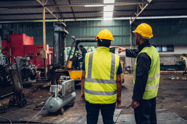 istock Workers Factory or Engineering work at factory site check up machine or products in site. Foreman or Technician checking Material or Machine on Plant. Heavy industry factory concept. 1496841009