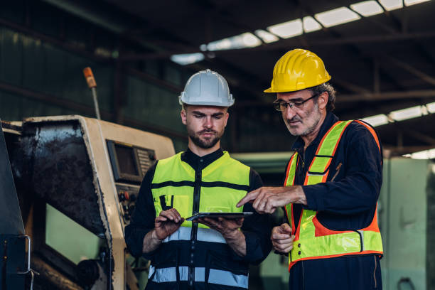 istock Workers Factory or Engineering work at factory site check up machine or products in site. Foreman or Technician checking Material or Machine on Plant. Heavy industry factory concept. 1496841035