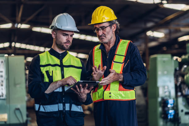 istock Workers Factory or Engineering work at factory site check up machine or products in site. Foreman or Technician checking Material or Machine on Plant. Heavy industry factory concept. 1496841063
