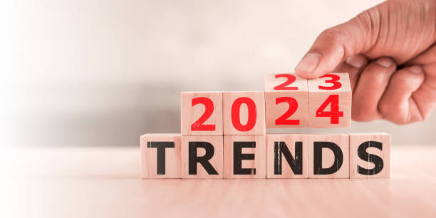 istock 2024 trend concept. Hand flip wood cube change year 2023 to 2024 1496842349