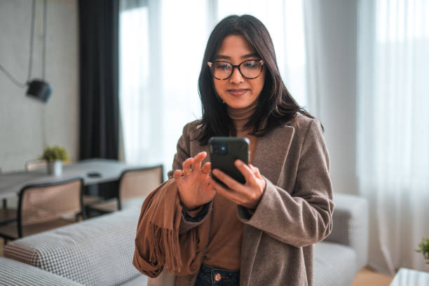 istock Potrait Of Millenial Woman Checking Messages Before Leaving for Work 1496845230