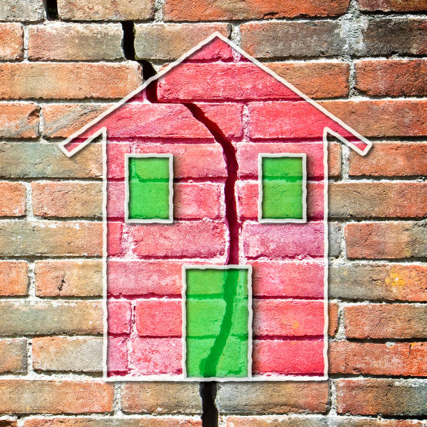 istock Old deeply cracked brick wall with a colored house drawn on it - earthquake and bradyseism concept 1496846507