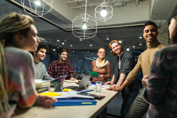 istock Happy freelancers talking on a meeting at casual office. 1496846551