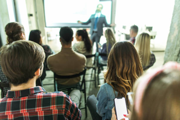 istock Back view of creative people on education event in the office. 1496847633