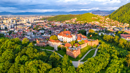 Brasov, Romania - May 2020. Stunning sunset drone view of The Citadel, medieval heritage of Transylvania.