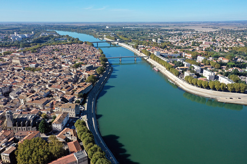 Arles is a coastal city and commune in the South of France with arround 51'000 residents. The image shows the historic city partially and the river rhone, captured during autumn season.