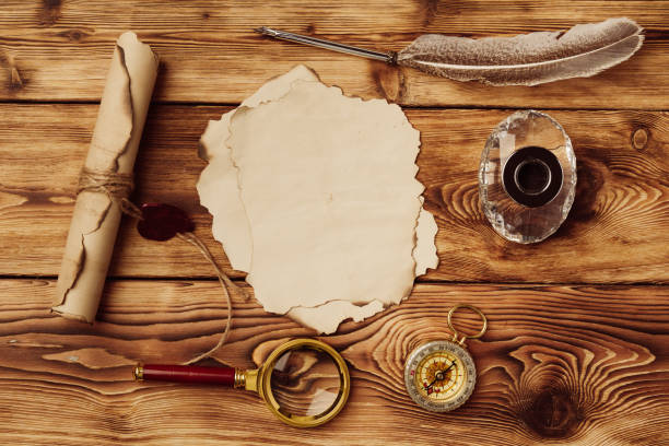 istock Old paper on brown wood background with feather 1496850216
