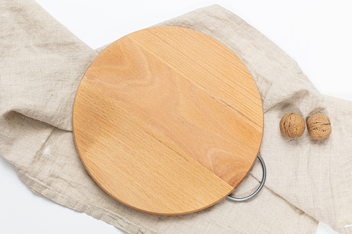 Kitchen utensils concept with round empty wooden or bamboo cutting board