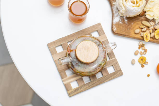 istock Glass refractory teapot with fruit tea in domestic kitchen 1496853527