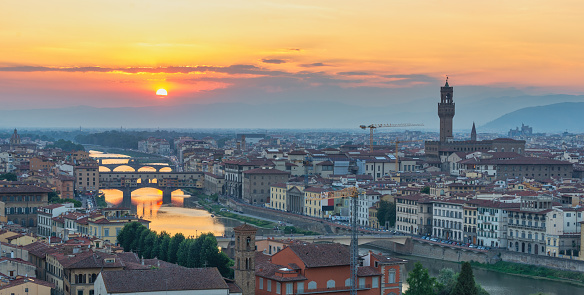 Florence Italy, panorama high angle view sunset city skyline at Ponte Vecchio Bridge and Arno River, Tuscany Italy
