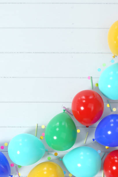 istock Colorful balloons with confetti and birthday candles corner border composition 1496857206