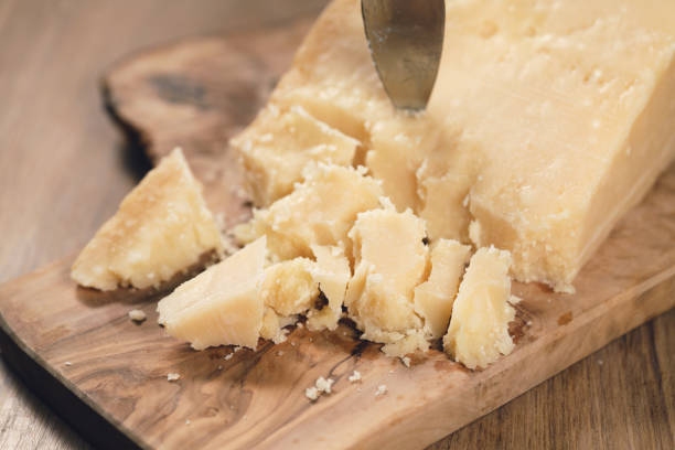 istock pieces of hard parmesan cheese on olive board from above 1496859775