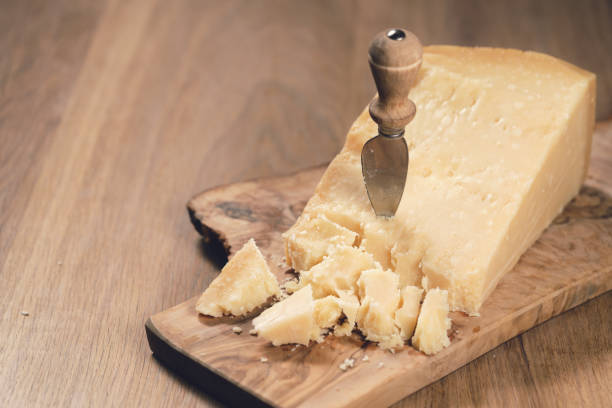 istock pieces of hard parmesan cheese on olive board from above 1496860540