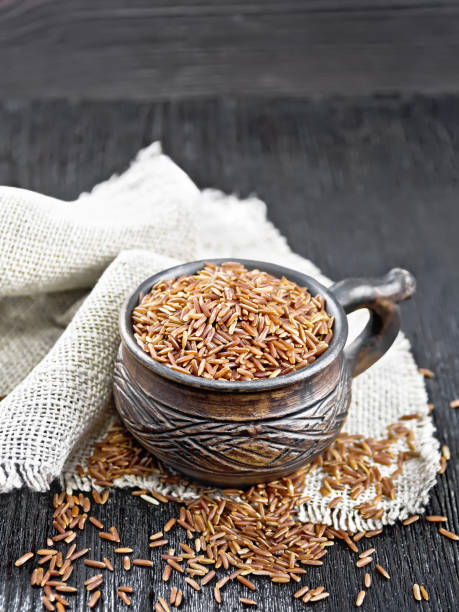 istock Rice red in cup on wooden board 1496860891
