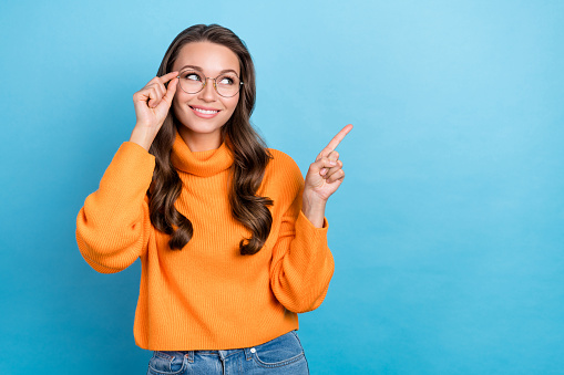 Photo attractive lady try new spectacles low prices advise optics shop wear knitted jumper isolated blue color background.