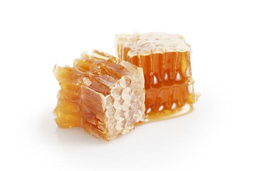 organic honey in honeycombs isolated on white background