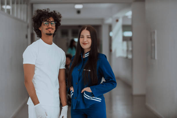 A young African-American doctor, accompanied by a nurse, stands together in the hallway of a modern hospital, exemplifying a diverse and dedicated healthcare team committed to collaboration, excellence, and providing patient-centered care with compassion and expertise. un joven médico afroamericano, acompañado por una enfermera, se encuentra en el pasillo de un hospital moderno, ejemplificando un equipo de atención médica diverso y dedicado comprometido con la colaboración, la excelencia y la prestación de atenció