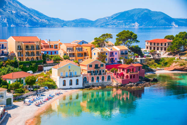 Assos, Greece. Picturesque village nestled on the idyllic Cephalonia Assos, Greece. Picturesque village nestled on the idyllic Cephalonia, Ionian islands. Turquoise colored bay, Mediterranean Sea, beautiful colorful houses. kefalonia stock pictures, royalty-free photos & images