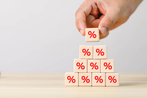 istock Hand picking financial interest rate on wooden block 1496864012
