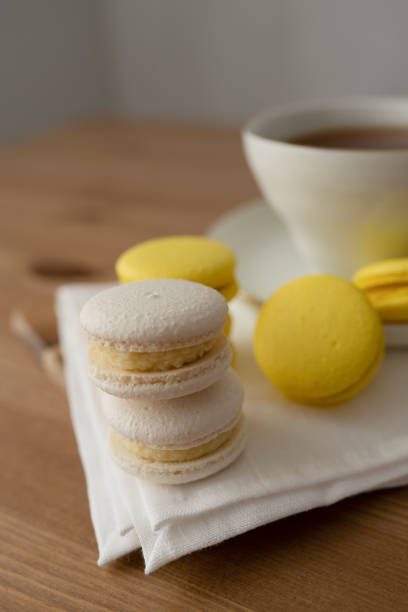 istock Macaroon and cup of tea on a wooden table, close up 1496864941