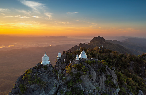 Beautiful morning high angle view, White pagoda on top of a high mountain Wat Phra Phutthabat Pu Pha Daeng or Wat Chaloem Phrakiat Phra Chom Klao Rachanusorn, Chae Hom, Lampang, Thailand.