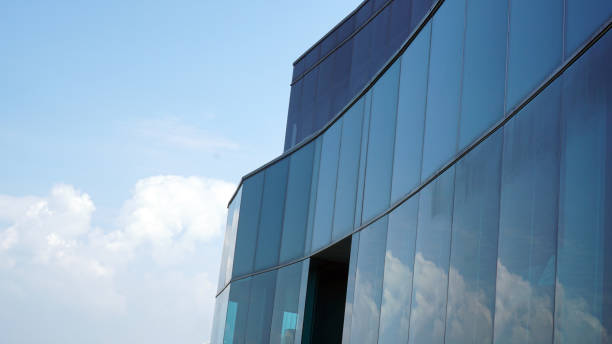 istock bottom view blue glasses building with sky and cloud background. Skyscraper, view of modern business building. Sky view landscape with modern blue glasses building. looking up perspective. Copy space 1496865862