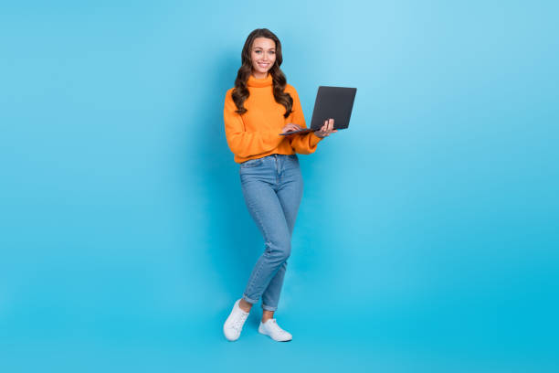 istock Photo of lady freelance worker using netbook for communication with clients partners isolated blue color background 1496866267