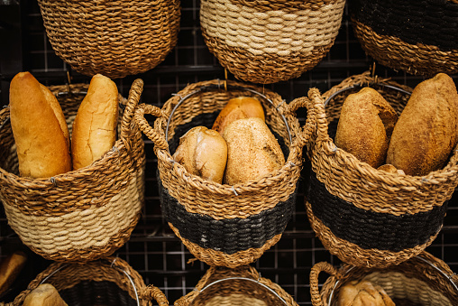 Different types of baked bread in a basket.