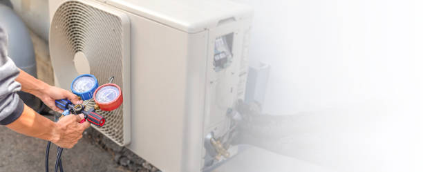 istock Air conditioning, HVAC service technician using gauges to check refrigerant and add refrigerant. 1496869103