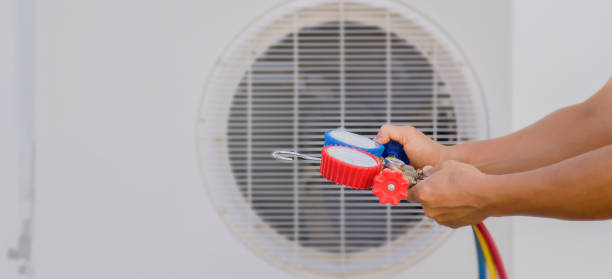 istock Air conditioning, HVAC service technician using gauges to check refrigerant and add refrigerant. 1496869204