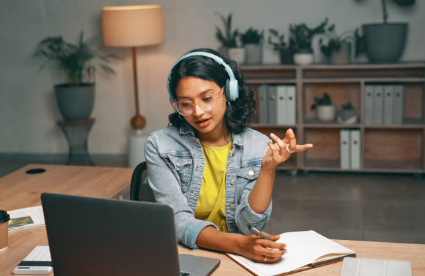 istock Student, laptop and asking for video call in night studying, distance learning or education for college, university or school. Serious, woman or talking in elearning webinar or questions at home 1496869763