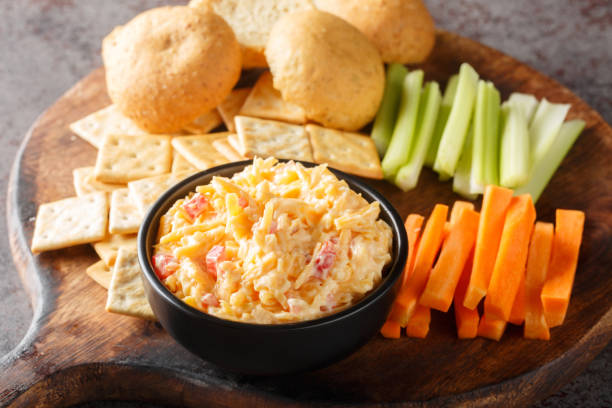 istock Pimento cheese with celery, carrot sticks and crackers closeup on the wooden board. Horizontal 1496870128
