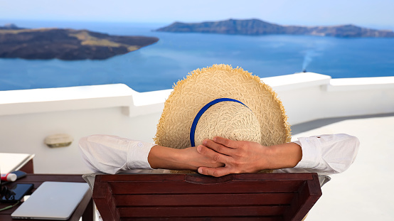 Relaxation of young man  lifestyle with hat  as looking view  in mediterranean  Oia ,Santorini,Greece