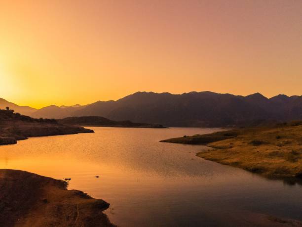 istock a river with mountain in the background at sunset 1496874393