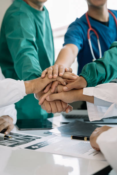 istock Doctors shaking hands, working together as a team at the hospital. 1496875717