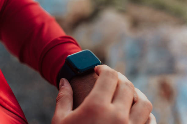 istock Man Using A Digital Smartwatch During Workout. Closeup View Of Man's Hands Checking An App In Smartwatch. Close-up Of A Clock That Shows Steps, Kilometers And bpm. 1496876011