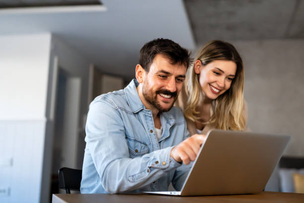 istock Multiethnic colleagues discussing project while working with laptop in office indoors 1496876376