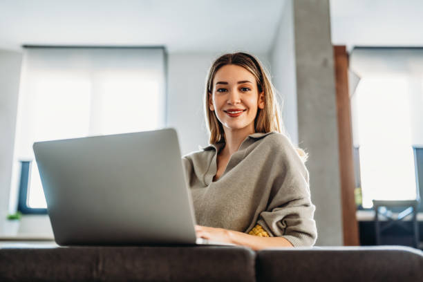 istock Home office. One smiling woman using laptop. Work, freelance, social media, technology concept. 1496877243