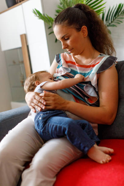 istock Mother Breastfeeding Her Baby Boy At Home 1496877394