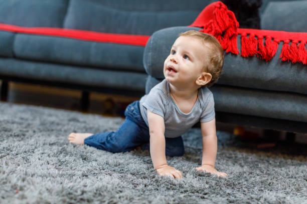 istock Cute Baby Crawling On Floor At Home 1496877435