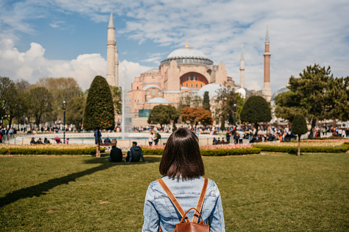 Young woman enjoying a view of Hagia Sofia in Istanbul, Turkey.