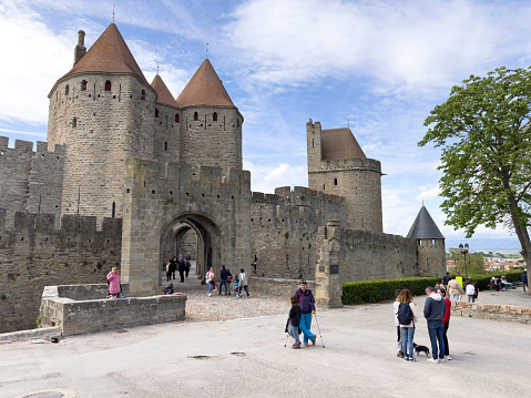 Carcassonne, FRANCE - APRIL 24, 2023: People are strolling through an alley in the old town of Carcassonne, France on April 24,2023 in Carcassonne in france. View on Old UNESCO town.