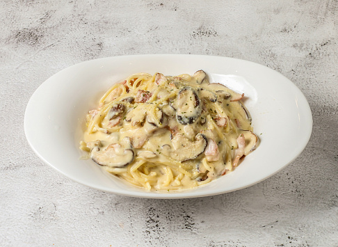 bacon and mushroom carbonara spaghetti with cream served in dish isolated grey background top view singapore fast food