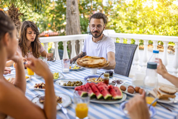 istock Friends eating fresh breakfast at balcony 1496883773