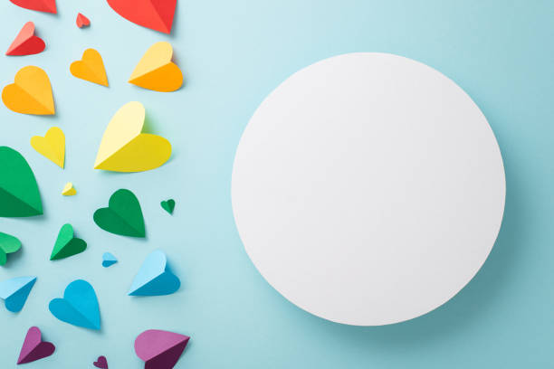 istock LGBT-themed parade accessories, including rainbow colored hearts arranged in a top view flat lay with empty circle for text or advertising 1496884869